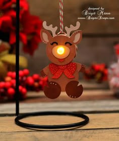 an ornament shaped like a reindeer with a light on it's nose