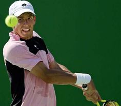 a man swinging a tennis racquet at a ball with a racket in his hand