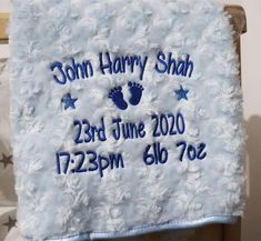 a baby's blanket with the birth date and foot prints on it is shown