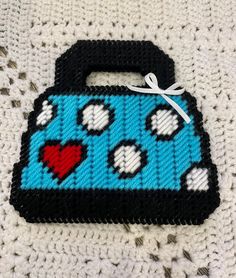 a blue and black bag with hearts on it