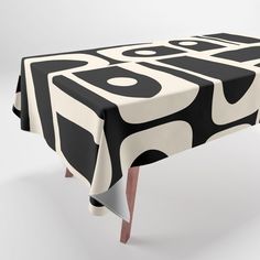 a black and white table cloth with an abstract design on the top that has been folded over