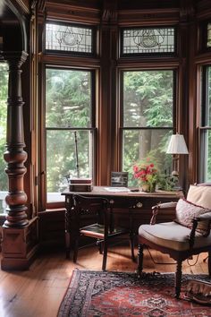 a chair sitting in front of a window next to a desk with a lamp on it