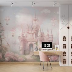 a desk with a computer on it in front of a wall mural that has a castle and hot air balloons