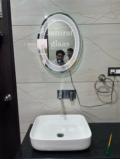 a bathroom sink with a mirror above it and a hair dryer next to it