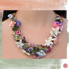 a woman wearing a necklace with flowers on it