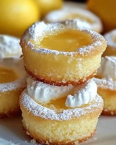 lemon filled donuts stacked on top of each other with icing and powdered sugar