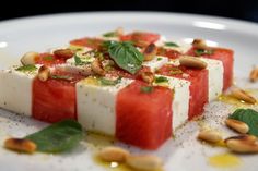 watermelon and feta with pine nuts on a white plate