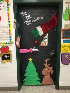 the grinch door decoration is decorated with santa's hat and other holiday decorations