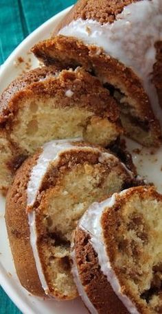 a white plate topped with slices of cake covered in frosting and cinnamon swirls