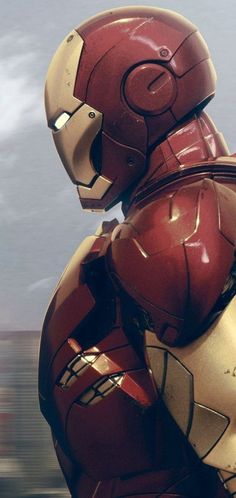 the iron man is standing in front of a cloudy sky