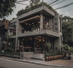 a large concrete building with plants growing on the balcony and balconies above it