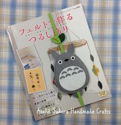 the brochure has an image of a totoro hanging from it's back