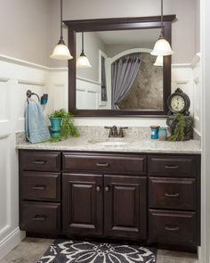 a bathroom with a large mirror above the sink