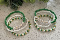 >>This listing is for a set of Three beaded bracelets. One green color with the custom lettering, one white solid strand, and one mix of green, white and gold. >>Youth sizes are approximately 5.5 >>Junior sizes are approximately 6 inches >>Adult Bracelets are approximately 7 inches >>for smaller or larger sizes, please send a custom request. >>Made with 4mm seed beads and sturdy jewelry elastic. >> Treat and store jewelry gently. >> Do not expose your jewelry to water or leave out in direct sunl Holiday Bead Bracelet, Small Bead Bracelet, Beaded Braclets, Holiday Bracelets, Green Beaded Bracelets, Spring Bracelet, Diy Jewelry Unique, Word Bracelet, Lucky Bracelet