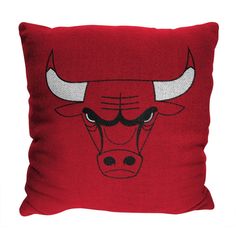 the chicago bulls pillow is red with white horns on it's face and black eyes