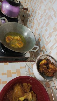 two pans filled with food sitting on top of a stove next to each other