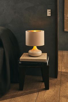 a lamp sitting on top of a wooden table