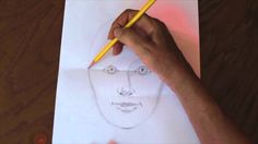 someone is drawing a man's face on paper