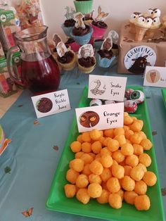 there are many desserts on the table for children to eat and have signs in front of them