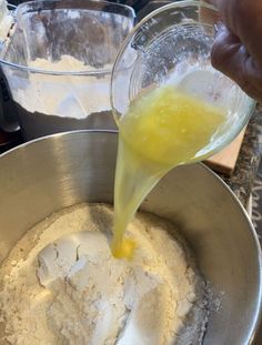 someone pouring batter into a bowl with flour