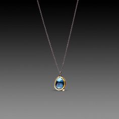 A brilliant rose cut London blue topaz is complimented with a single twinkling white diamond. Bezel set in 22k gold backed with sterling silver, on an oxidized sterling silver chain. Pendant measures approximately 1/2 inch tall. Matte finish. Mejuri Topaz Necklace, Blue Rose Cut Diamond Pendant Jewelry, Blue Pendant Necklaces With Rose Cut Diamonds, Blue Rose Cut Diamond Pendant Necklace, Gold Jewelry With Rose Cut Diamonds And Blue Topaz, London Blue Topaz Necklace, Silver Chain Pendant, Necklace With Diamond, Blue Topaz Necklace