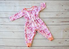 Our Baby Hazel Romper is perfect for those chilly days. This romper is made from 95% cotton, 5% spandex for ultimate comfort for your little one. The elasticized waist with faux drawstring detail adds a bit of girly fun to the Hazel. For sizes 6-9M and above, you choose if you prefer snaps along the legs for easy access diaper changes, or if snapless is more your style! Rompers 3-6M and under all come with snaps along the legs, as the neckline is not designed to fit the hips and bum through. Doe Playful Fitted Jumpsuits And Rompers For Loungewear, Playful Long Sleeve Bubble Romper For Loungewear, Playful Long-sleeve Bubble Romper For Loungewear, Playful Pink Long Sleeve Jumpsuits And Rompers, Playful Long Sleeve Pink Jumpsuits And Rompers, Fitted Cotton Bubble Romper For Loungewear, Pink Long Sleeve Jumpsuits And Rompers For Playtime, Playful Loungewear Jumpsuits For Babies, Pink Jumpsuits And Rompers For Playwear