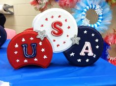 three red, white and blue letters with stars on them are sitting on a table