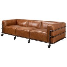 a brown leather couch sitting on top of a metal frame