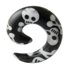 a black and white ring with skulls on the inside, in the shape of a letter s