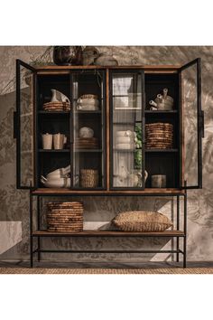 an old fashioned china cabinet with baskets and bread