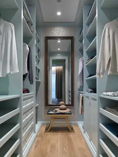 an empty walk in closet with lots of clothes