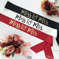 a red and white sash with the words miss to mrs on it next to flowers