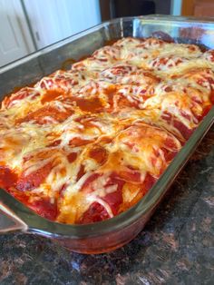 a casserole dish with meat and cheese in it sitting on a counter top