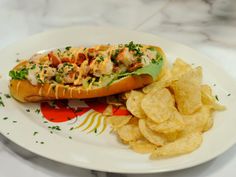 a plate with a sandwich and chips on it