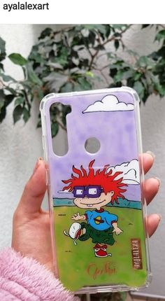 someone holding up a phone case with an image of a cartoon character on the back