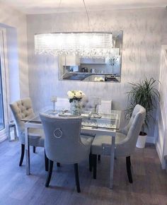 a dinning room table with chairs and a chandelier