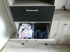 an open drawer with clothes in it