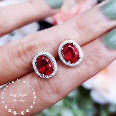 Oval Halo Setting Earrings For Anniversary, Oval Gemstone Earrings For Anniversary, Red Oval Earrings For Anniversary, Oval Ruby Jewelry With Halo Design, Red Oval Jewelry With Halo Design, Oval Red Halo Jewelry, Silver Oval Halo Earrings, Oval Red Jewelry With Halo, Oval Red Jewelry With Halo Design