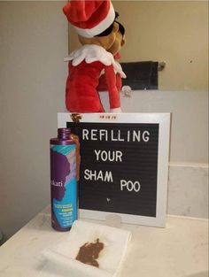 a stuffed animal sitting on top of a table next to a sign that says refilling your shampoo