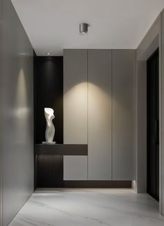 a white vase sitting on top of a counter in a room next to a doorway