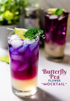 the butterfly pea flower cocktail is garnished with mint