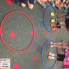 several children standing in a circle on the floor