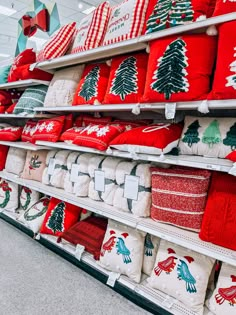 red and white christmas pillows on display in a store