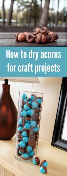 a vase filled with blue and brown rocks on top of a wooden table next to a mirror