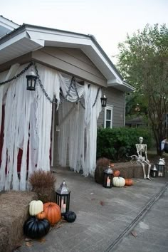 an outdoor halloween scene with pumpkins and decorations