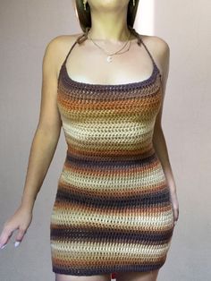 a woman in a crocheted dress is posing for the camera