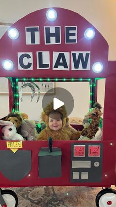 a child's costume is shown in front of the claw machine with stuffed animals