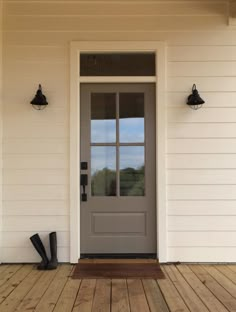 the front door of a house with an ad for woodlook tiles on it