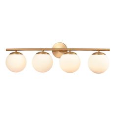 three light bathroom fixture with brass finish and white glass globes on the bottom half