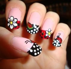 a ladybug nail with polka dots and flowers on it